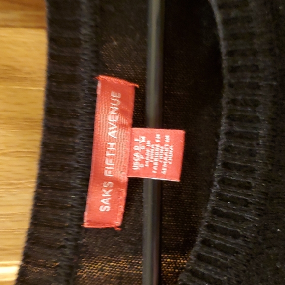 Long sleeve light weight sweater with skull logo from Saks. Gently worn. - Picture 2 of 3